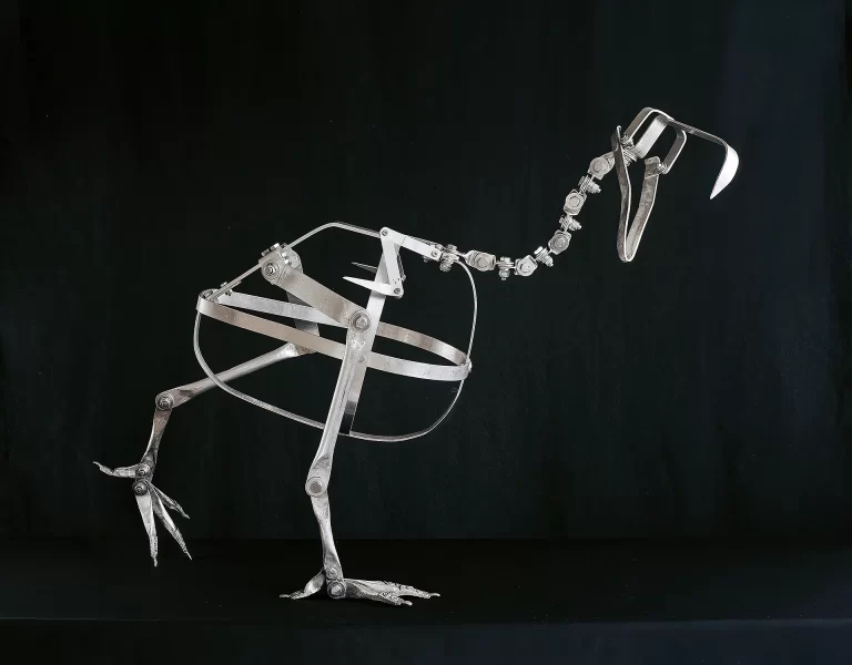 Professional mechanical framework featuring polished metal components and pivot joints for mounting dodo specimen. Museum-grade armature with central torso cage and articulated positioning elements for natural history reconstruction displays.