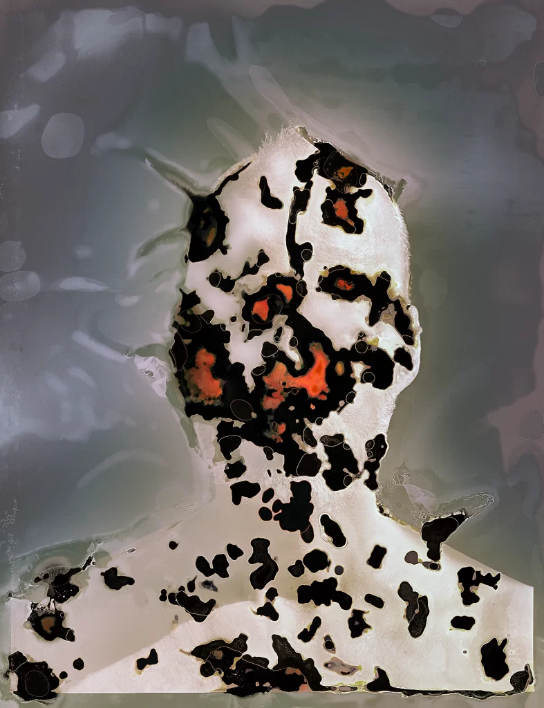 Experimental self-portrait produced via subterranean photographic processing showing frontal figure in creamy whites with dark biological specimens. Composition exhibits cellular mapping effects, scattered organic islands with crimson chemical reactions, and translucent atmospheric background from earthbound decomposition processes.
